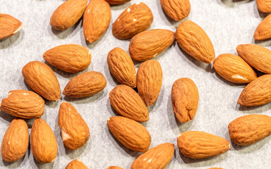 almonds top view closeup on pale white paper background