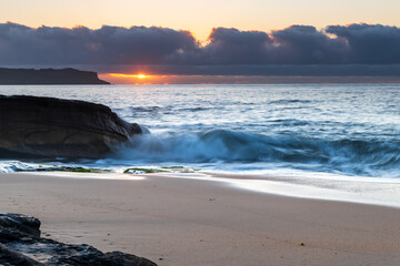Fototapeta na wymiar Sunrise by the sea with cloud bank on the horizon