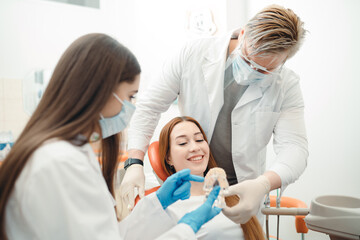Fototapeta premium Dentists at the clinical center tell the client how to brush their teeth properly