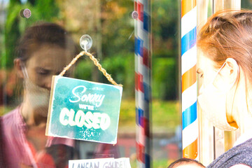 Excuse me, we are closed in business with a woman's reflection. economic crisis concept