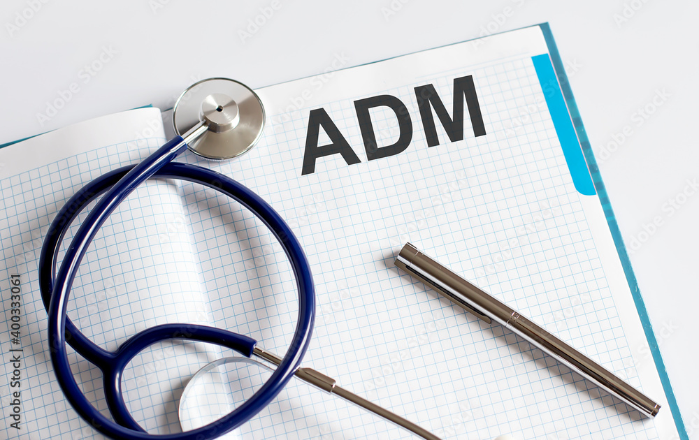 Poster paper with text adm on table with stethoscope