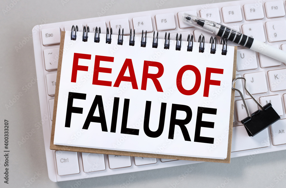 Poster fear of failure. text on white paper on white keyboard background and gray background