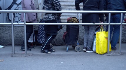 Europe, Italy , Milan December 2020, poor Italian and foreign people with masks lined up at Pane...
