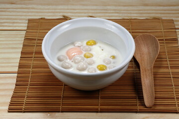 Chinese rice balls in sweet coconut milk. Pumpkin and Taro glutinous rice balls in the bowl. Dessert in Traditional Chinese festival (Dongzhi Festival) concept. Famous recipe in New Year ceremony.