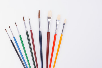 Obraz premium Row of colorful paint brushes. Isolated with copy space