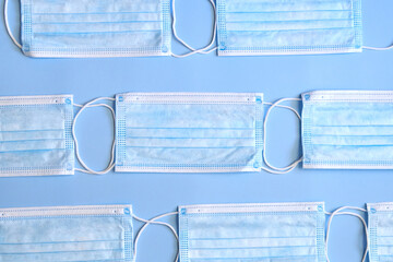 Medical masks on a blue background, the concept of viral diseases.