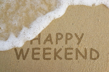 Fototapeta premium Happy Weekend! Written in the sand at the beach. Holiday concept.