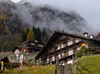 ITALY, ALAGNA VALSESIA. 05 NOVEMBER 2016. Small Alpine town street with typical houses ITALY, ALAGNA VALSESIA. 05 NOVEMBER 2016,