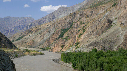 Fototapeta na wymiar Landscape view of the Panj river valley bordering Afghanistan in Darvaz district, Gorno-Badakshan, the Pamir region of Tajikistan