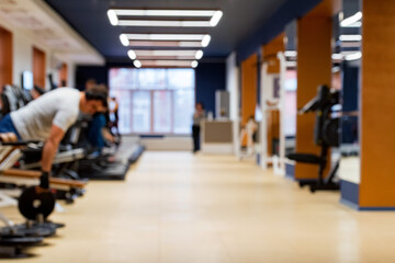 Blurred people in sport gym on treadmills and exercise machine