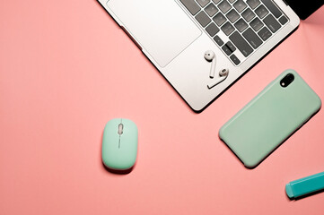 Colorful layout composition with a turquoise computer mouse, smartphone in a light blue silicon...