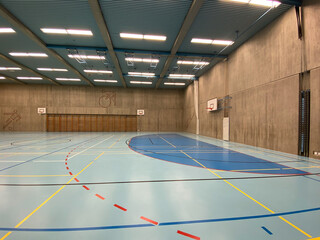 Interior of empty modern gymnasium - basketball, floorball, badminton, velleyball, soccer indoor sport courts