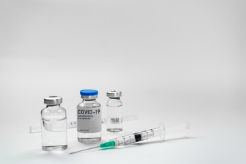 Covid19 Vaccine syringes and medicine bottles in white environment