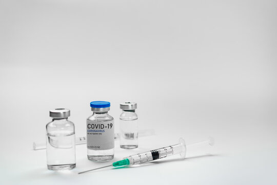 Covid19 Vaccine syringes and medicine bottles in white environment