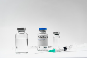 Covid19 Vaccine syringes and medicine bottles in white environment