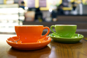 Coffee to go. Fresh latte in a cup on a wooden table in a cafe.
