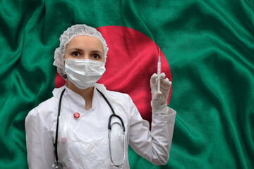 Young woman doctor in medical uniform on the background of the national flag of Bangladesh is holding a syringe. The concept of a new vaccine against the disease, flu vaccine vaccination.