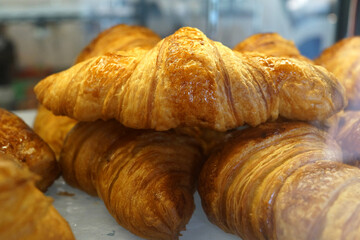 Close up of freshly baked croissants in a bakery stall