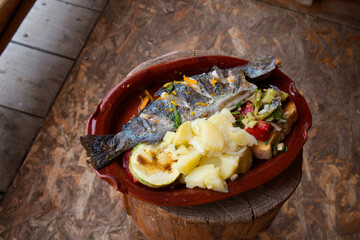 The traditional dish of Eastern Serbia - grilled mountain trout with garlic, lemon, parsley and olive oil

