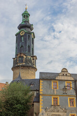 The tower of Schloss Weimar peeking over the surrounding houses, seen from the Green Market
