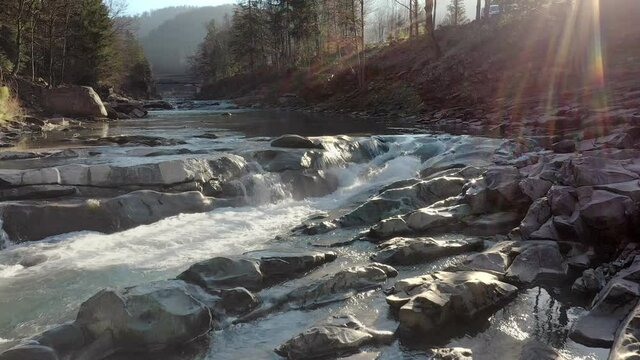 Wild mountain river flowing with stone boulders and stone rapids. Probiy river in the Carpathians, Ukraine