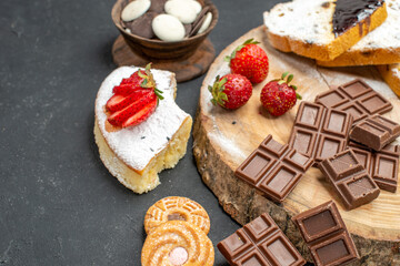 front view cake slices with choco bars and cookies on grey background biscuits fruit sweet