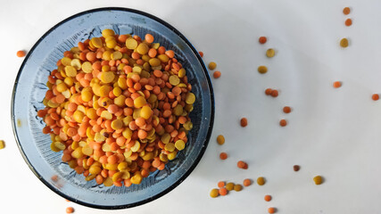 split chickpeas in glass bowl on a white isolated surface