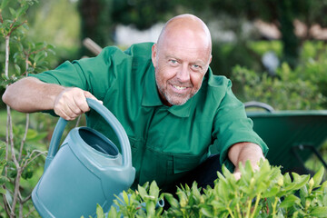 senior gardener using watering can