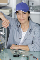 attractive smiling female digital electronic engineer looking at camera