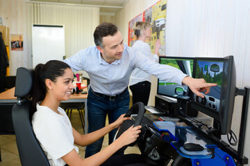 student of a driving school doing the driving simulation