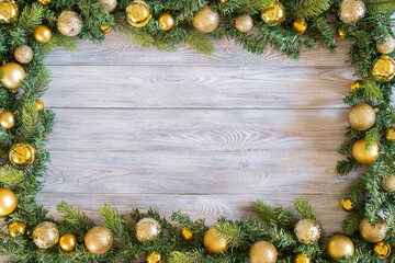 Green branch of christmas tree decorated with christmas decor on wooden table © Tereza
