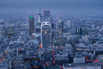 Fototapeta na wymiar Illuminated London City skyline at dusk blue hour from above