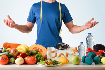 Healthy food and sport accessories with scale and sportsman