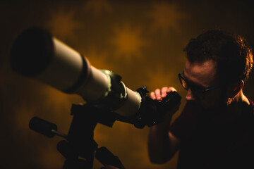 Fototapeta premium Amateur astronomer looking at the stars with a telescope. Astronomy and astrology concept.