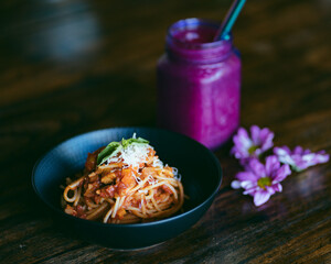 Vegetarian pasta and dragon juice on background