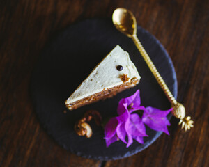 Fototapeta premium Tasty carrot cake on the plate with spoon and flower