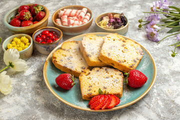 front view yummy cake slices with strawberries on light background fruit sweet cake pies