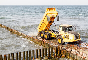 heavy truck during the construction of a breakwater