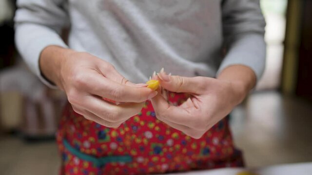 Crop woman with tasty tortellini at home