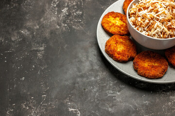 front view fried cutlets with cooked rice on a dark background dish rissole meat