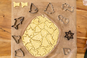 Fototapeta na wymiar christmas cookies cutters on the table; recipe biscuit; decorating holiday biscuits