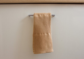 the towel hangs on the handle of the kitchen drawer
