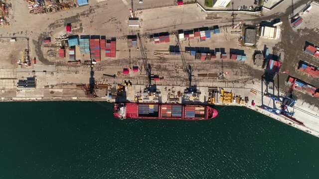 Aerial drone footage of a cargo terminal with cargo ships in Magadan, Russia. 4K.
