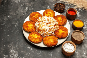 top view fried cutlets with cooked rice and seasonings on dark background food dish meat