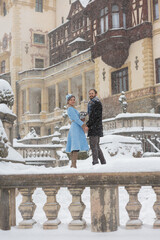 Fototapeta na wymiar Happy Young Couple in Winter Park. Family outdoors at the castle.