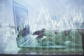 Double exposure of woman hands typing on computer and forex chart hologram drawing. Stock market...