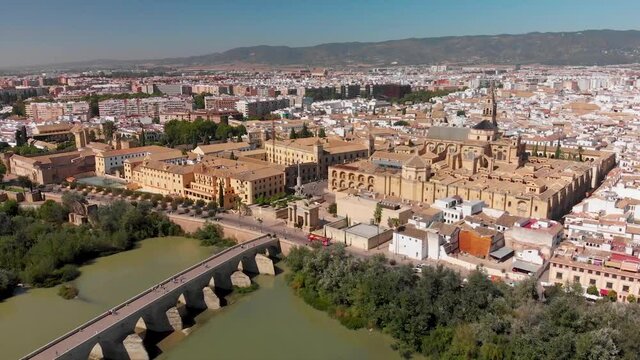 Aerial overview of old Spanish city with stone bridge