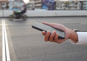 woman hold mockup white smartphone with blurred background. For Graphic display montage., blured backdrop