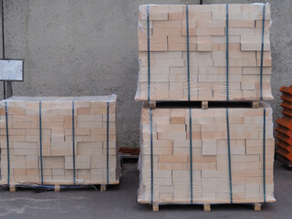 New fire-resistant fireclay brick for sale in a package in a warehouse. Natural building material...