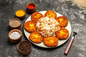 top view fried cutlets with cooked rice and seasonings on a dark background food dish photo meat